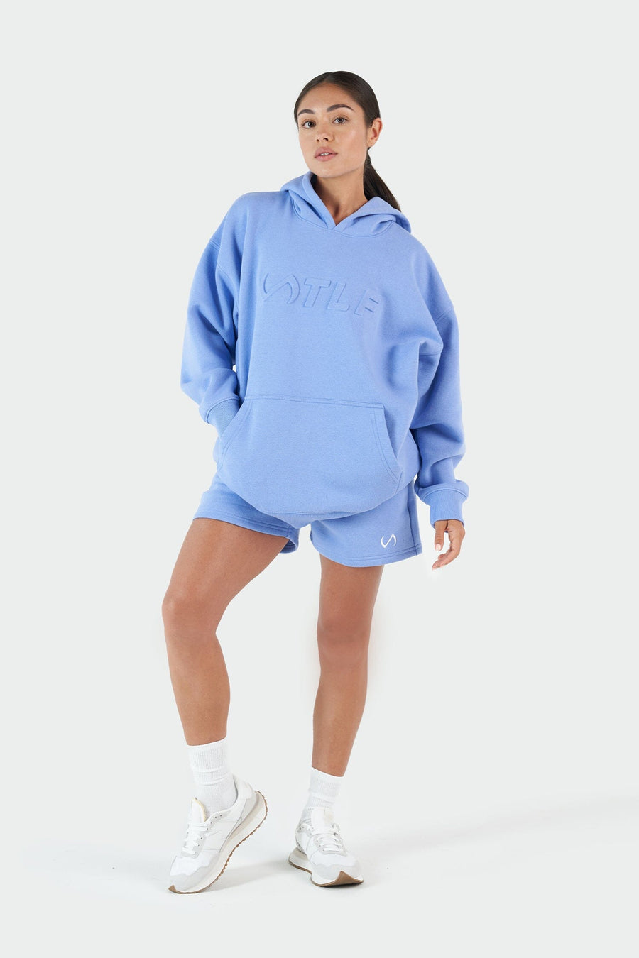 Girl Wearing Periwinkle Hoodie and Shorts